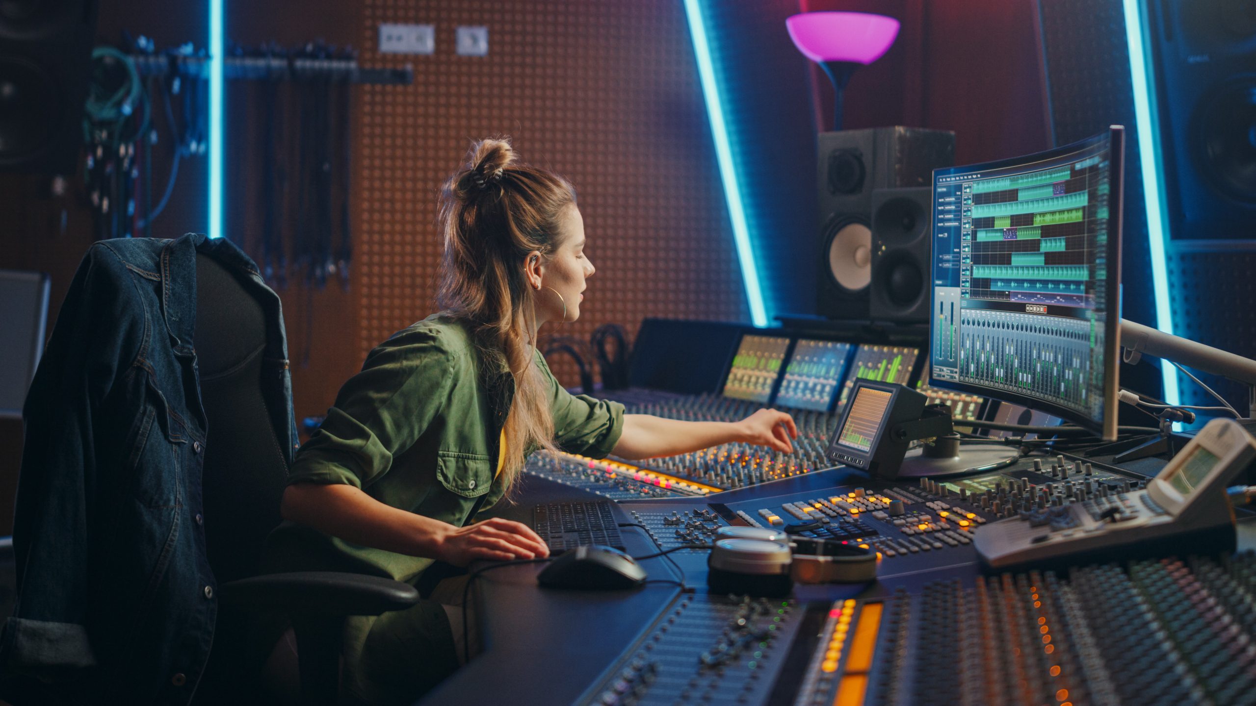 Beautiful Female Audio Engineer Working in Music Recording Studio